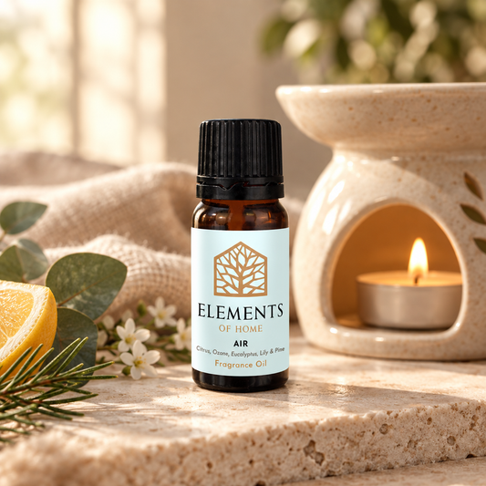 Air fragrance oil 10ml bottle beside a lit ceramic oil burner – Elements of Fragrance