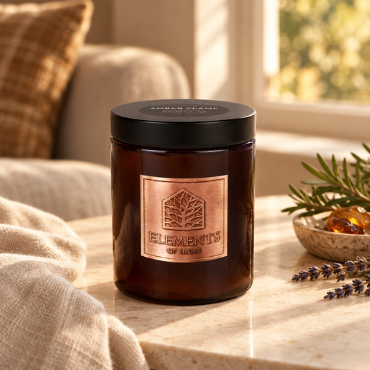 Amber Flame 140g luxury candle in an amber glass jar in a cosy living room – Elements of Fragrance
