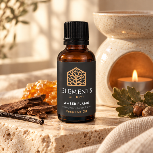 Amber Flame 30ml fragrance oil beside a lit ceramic oil burner – Elements of Fragrance