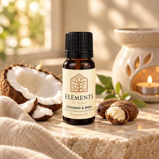 Coconut & Shea fragrance oil 10ml bottle beside a lit ceramic oil burner – Elements of Fragrance