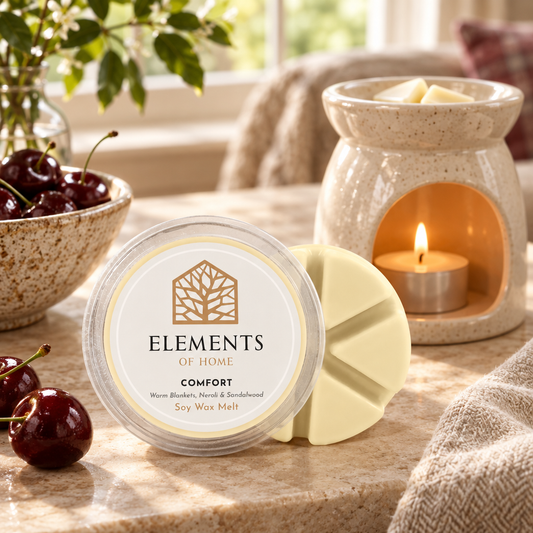 Comfort 50g soy wax melt snap pot beside a lit ceramic wax burner – Elements of Fragrance