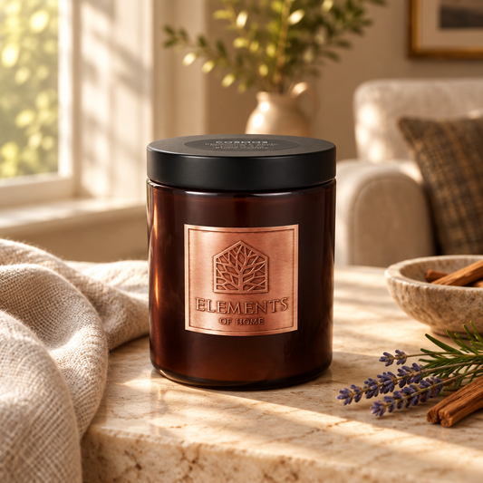 Cosmos 140g luxury candle in an amber glass jar in a cosy living room – Elements of Fragrance