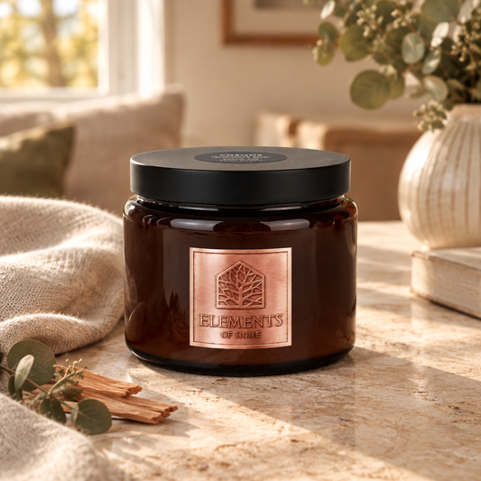 Cosmos 413g luxury candle in an amber glass jar in a cosy living room – Elements of Fragrance