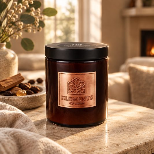 Dusk 140g luxury candle in an amber glass jar in a cosy living room – Elements of Fragrance