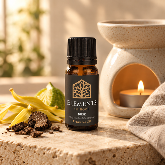 Dusk 10ml fragrance oil beside a lit ceramic oil burner – Elements of Fragrance