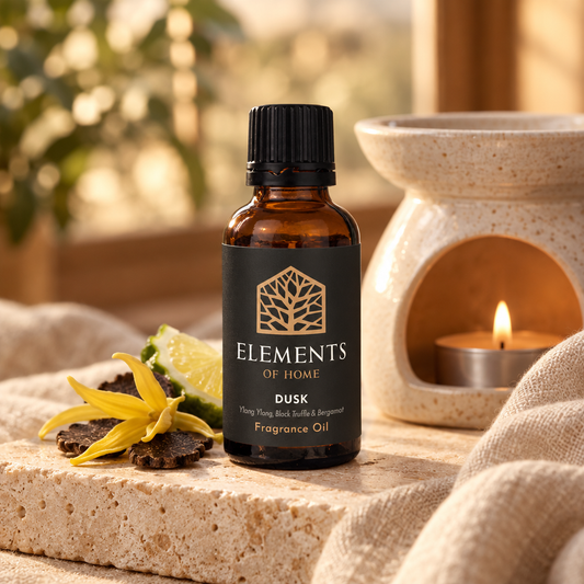 Dusk 30ml fragrance oil beside a lit ceramic oil burner – Elements of Fragrance