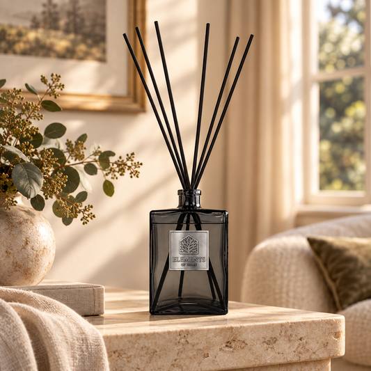 Dusk 1L luxury reed diffuser in a black glass bottle styled in a sunlit living room – Elements of Fragrance