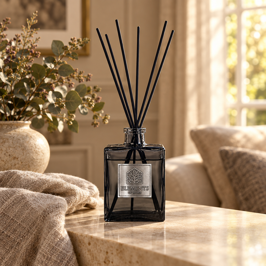 Dusk 200ml luxury reed diffuser in a black glass bottle styled in a sunlit living room – Elements of Fragrance