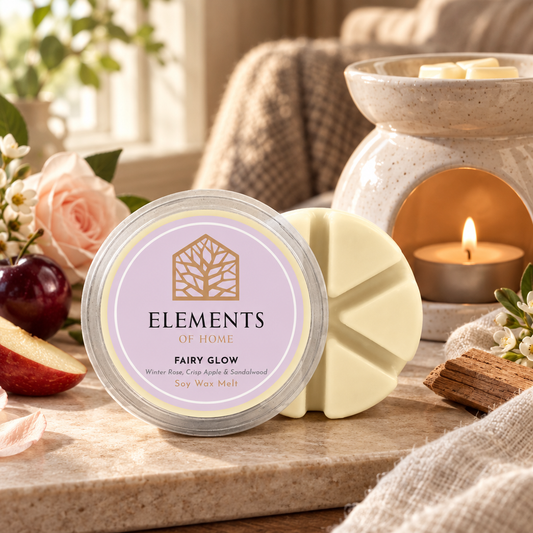 Fairy Glow 50g soy wax melt snap pot beside a lit ceramic wax burner – Elements of Fragrance