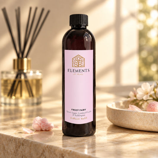 Frost Fairy reed diffuser refill bottle beside a reed diffuser – Elements of Fragrance