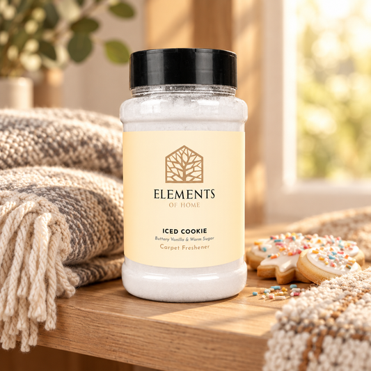 Iced Cookie scented carpet sprinkles shaker tub on a wooden shelf with cosy throws – Elements of Fragrance