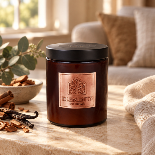 Igneous 140g luxury candle in an amber glass jar in a cosy living room – Elements of Fragrance