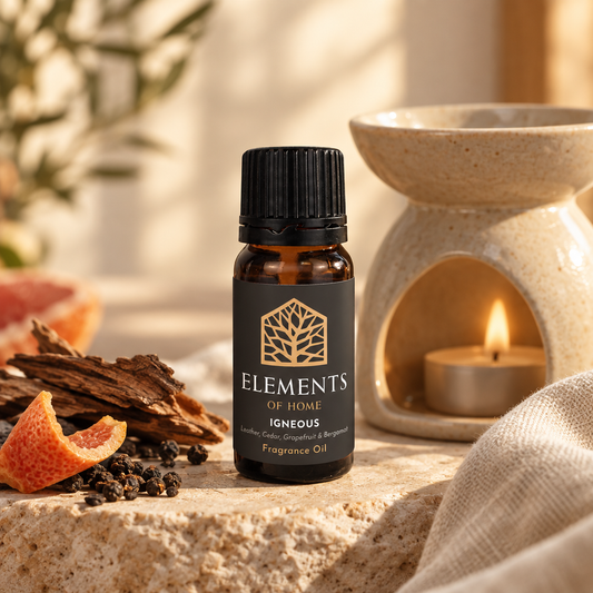 Igneous 10ml fragrance oil beside a lit ceramic oil burner – Elements of Fragrance