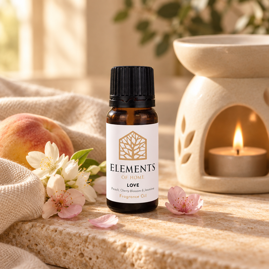 Love fragrance oil 10ml bottle beside a lit ceramic oil burner – Elements of Fragrance
