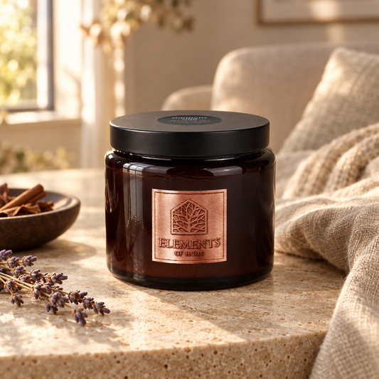 Midnight Oud 413g luxury candle in an amber glass jar in a cosy living room – Elements of Fragrance