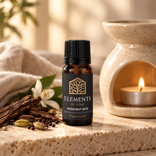 Midnight Oud 10ml fragrance oil beside a lit ceramic oil burner – Elements of Fragrance