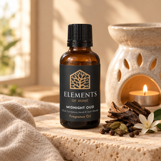 Midnight Oud 30ml fragrance oil beside a lit ceramic oil burner – Elements of Fragrance