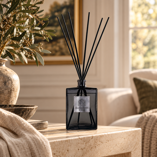 Midnight Oud 1L luxury reed diffuser in a black glass bottle styled in a sunlit living room – Elements of Fragrance