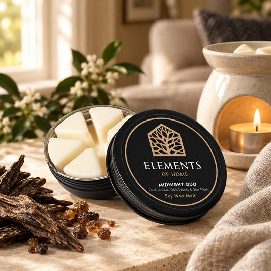 Midnight Oud 50g soy wax melt in a black tin beside a lit ceramic wax burner – Elements of Fragrance