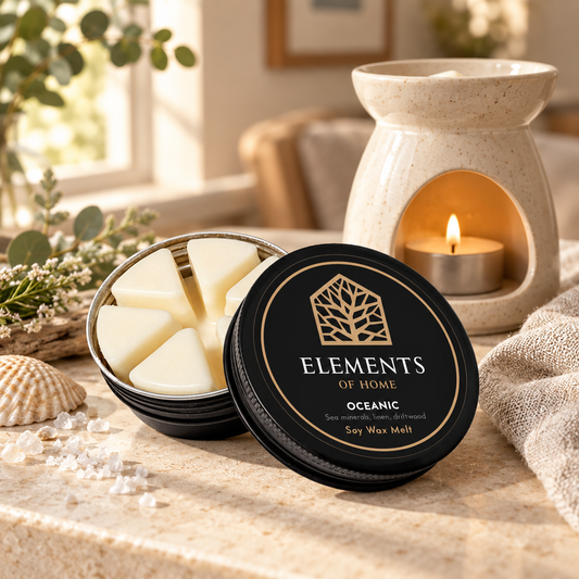 Oceanic 50g soy wax melt in a black tin beside a lit ceramic wax burner – Elements of Fragrance