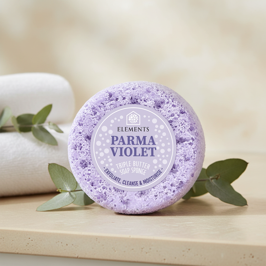 Parma Violet triple butter soap sponge on a bathroom shelf with white towels – Elements of Fragrance