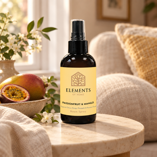 Passionfruit & Mango room spray on a side table in a sunlit living room – Elements of Fragrance