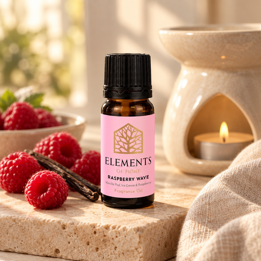 Raspberry Wave fragrance oil 10ml bottle beside a lit ceramic oil burner – Elements of Fragrance