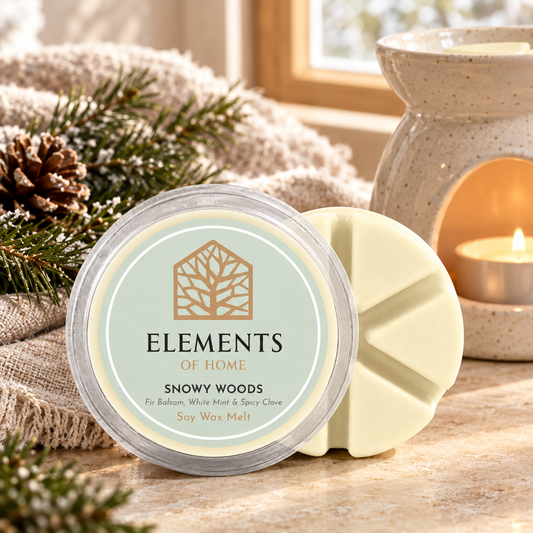 Snowy Woods 50g soy wax melt snap pot beside a lit ceramic wax burner – Elements of Fragrance