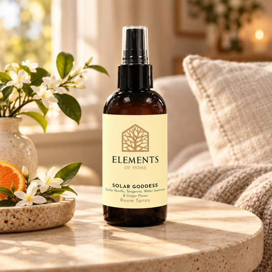 Solar Goddess room spray on a side table in a sunlit living room – Elements of Fragrance