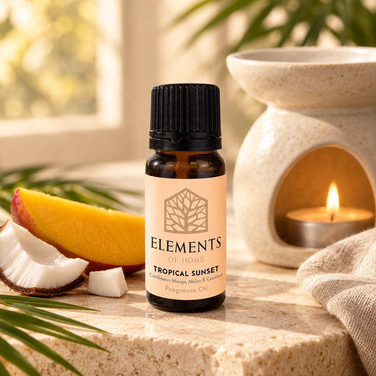 Tropical Sunset fragrance oil 10ml bottle beside a lit ceramic oil burner – Elements of Fragrance