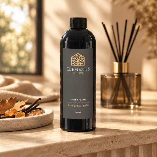 Amber Flame 500ml reed diffuser refill bottle beside a reed diffuser – Elements of Fragrance