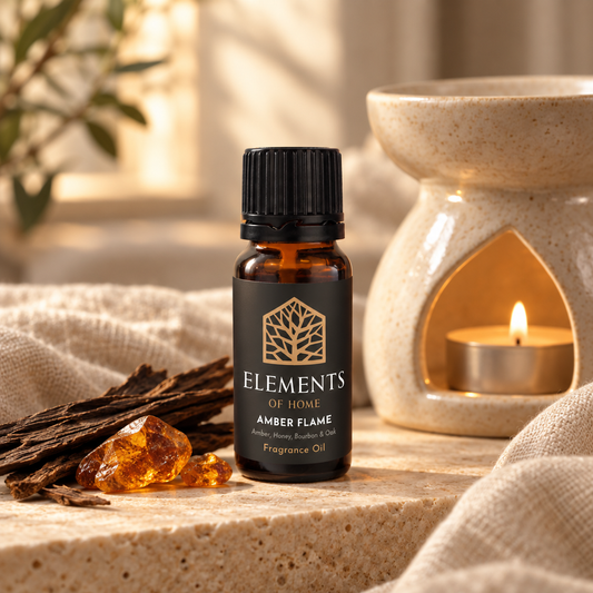 Amber Flame 10ml fragrance oil beside a lit ceramic oil burner – Elements of Fragrance