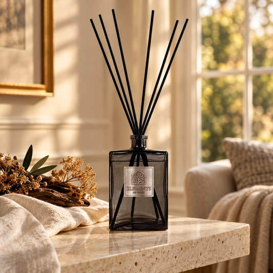 Amber Flame 1L luxury reed diffuser in a black glass bottle styled in a sunlit living room – Elements of Fragrance
