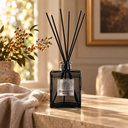 Amber Flame 200ml luxury reed diffuser in a black glass bottle styled in a sunlit living room – Elements of Fragrance