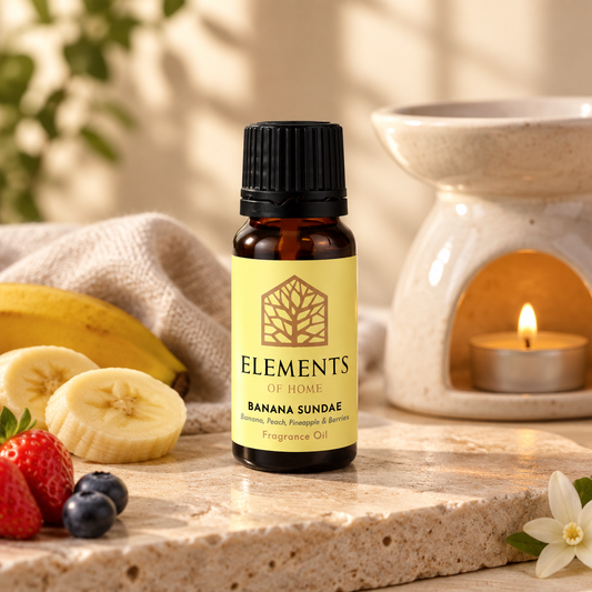 Banana Icecream Sundae fragrance oil 10ml bottle beside a lit ceramic oil burner – Elements of Fragrance