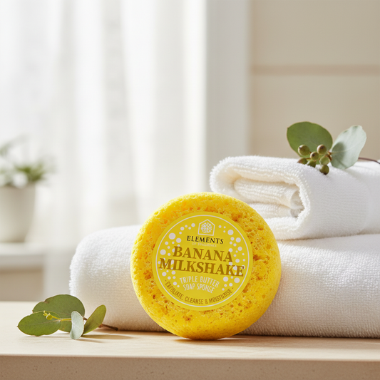 Banana Milkshake triple butter soap sponge on a bathroom shelf with white towels – Elements of Fragrance