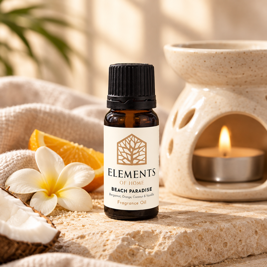 Beach Paradise fragrance oil 10ml bottle beside a lit ceramic oil burner – Elements of Fragrance