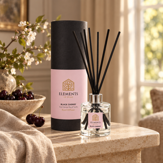 Black Cherry 100ml reed diffuser with black reeds styled in a sunlit living room – Elements of Fragrance
