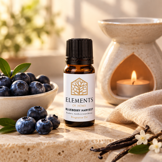 Blueberry Harvest fragrance oil 10ml bottle beside a lit ceramic oil burner – Elements of Fragrance