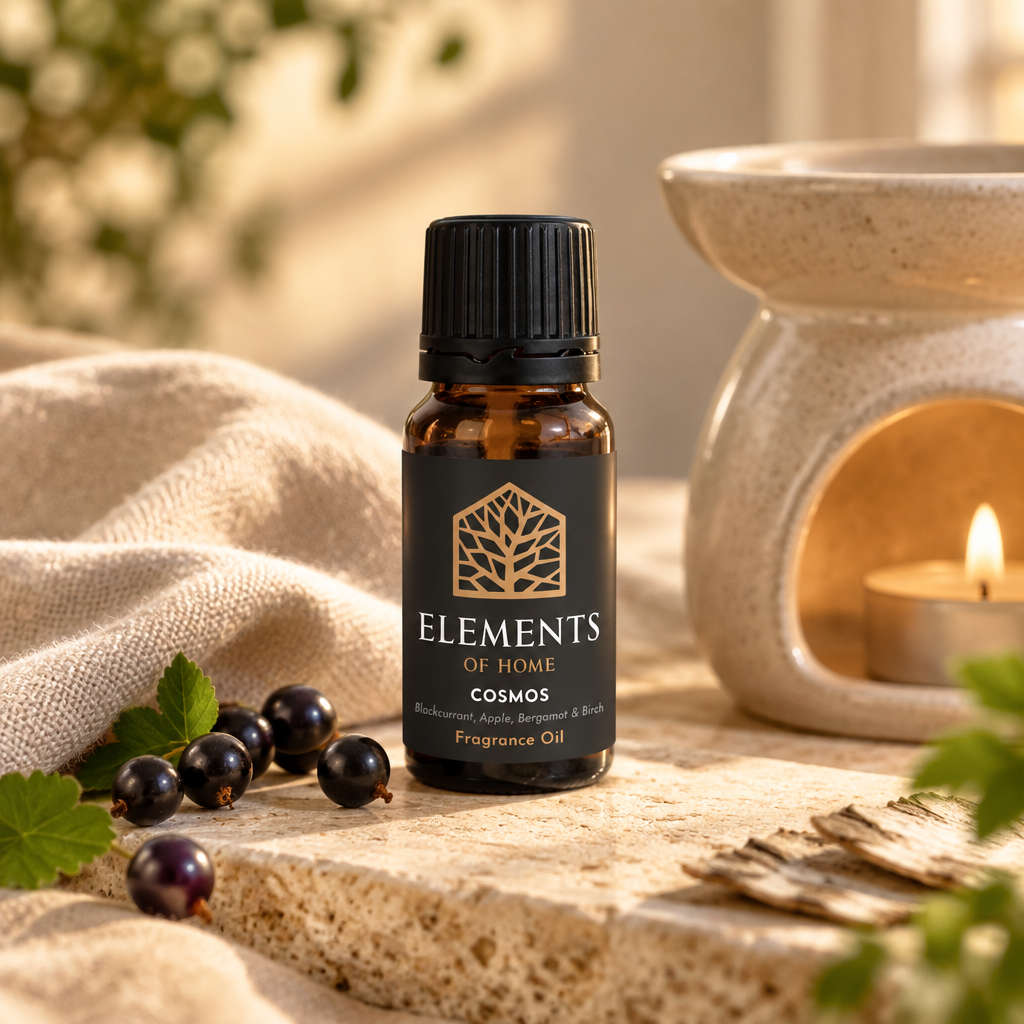 Cosmos 10ml fragrance oil beside a lit ceramic oil burner – Elements of Fragrance