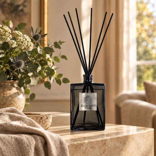 Cosmos 1L luxury reed diffuser in a black glass bottle styled in a sunlit living room – Elements of Fragrance