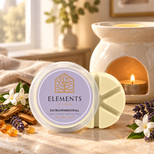 Extraterrestrial 50g soy wax melt snap pot beside a lit ceramic wax burner – Elements of Fragrance
