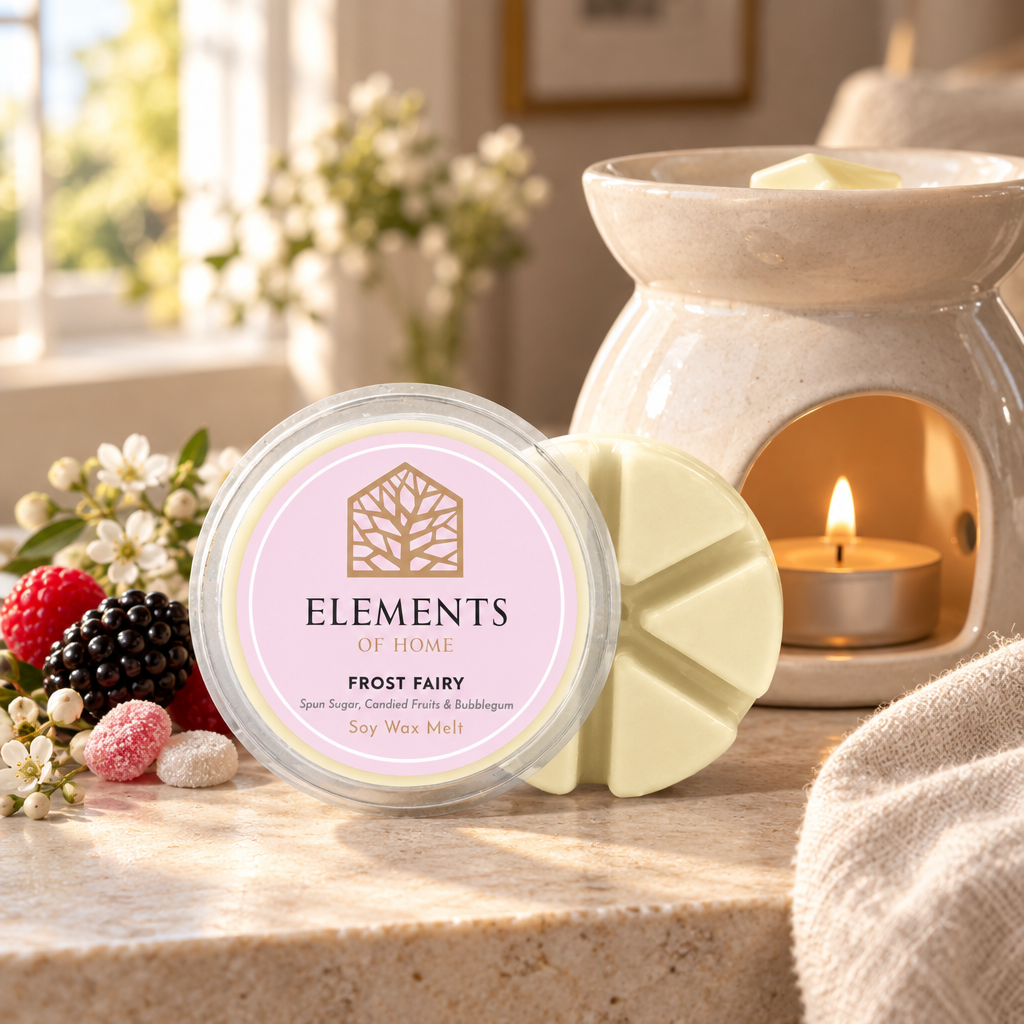 Frost Fairy 50g soy wax melt snap pot beside a lit ceramic wax burner – Elements of Fragrance