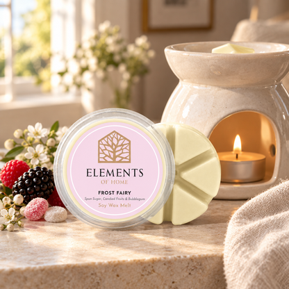 Frost Fairy 50g soy wax melt snap pot beside a lit ceramic wax burner – Elements of Fragrance