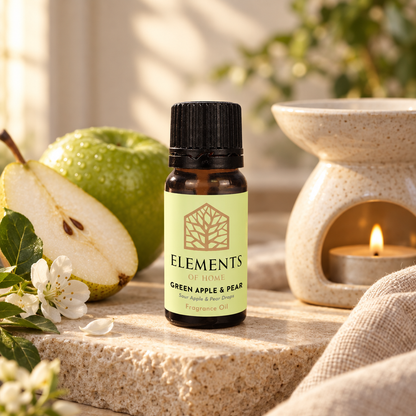 Green Apple & Pear fragrance oil 10ml bottle beside a lit ceramic oil burner – Elements of Fragrance