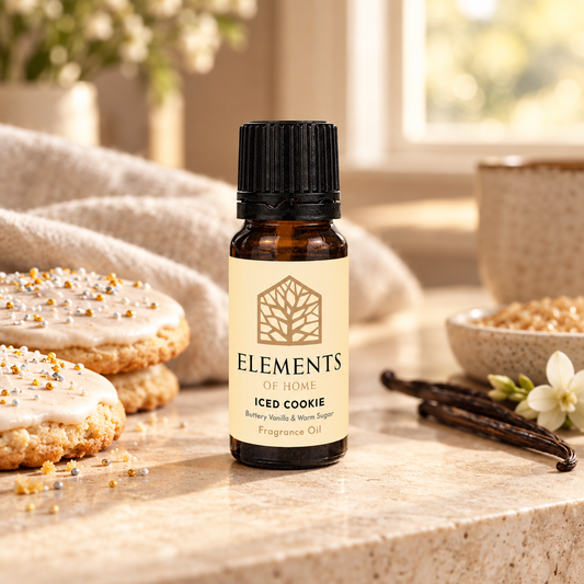 Iced Cookie fragrance oil 10ml bottle beside a lit ceramic oil burner – Elements of Fragrance