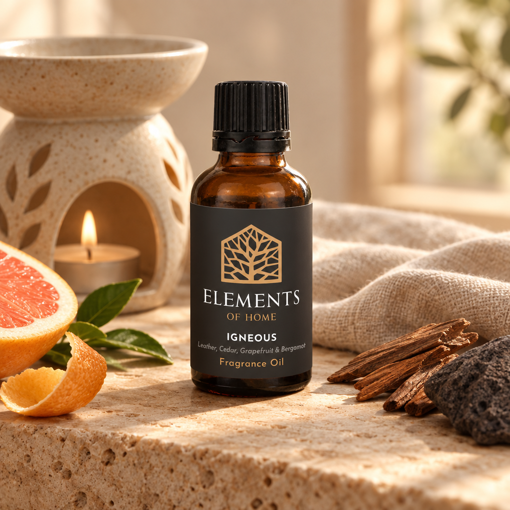 Igneous 30ml fragrance oil beside a lit ceramic oil burner – Elements of Fragrance