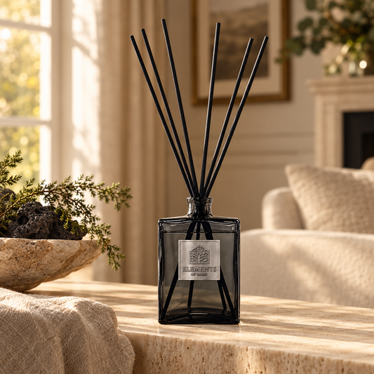 Igneous 1L luxury reed diffuser in a black glass bottle styled in a sunlit living room – Elements of Fragrance