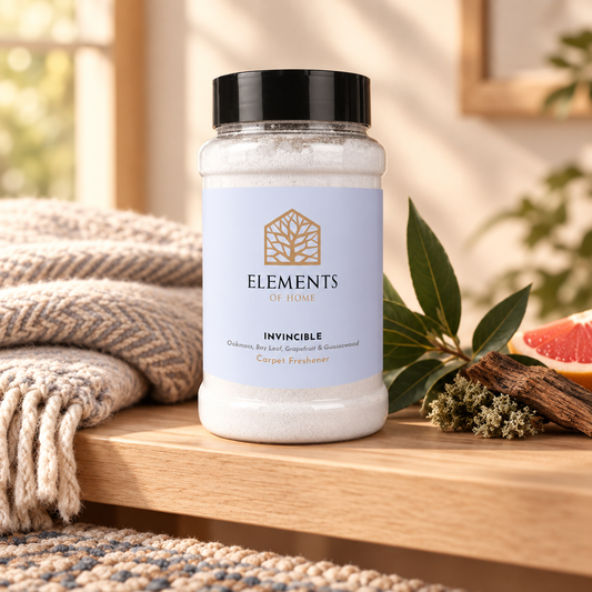 Invincible scented carpet sprinkles shaker tub on a wooden shelf with cosy throws – Elements of Fragrance