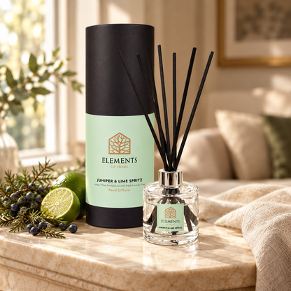 Juniper & Lime Spritz 100ml reed diffuser with black reeds styled in a sunlit living room – Elements of Fragrance